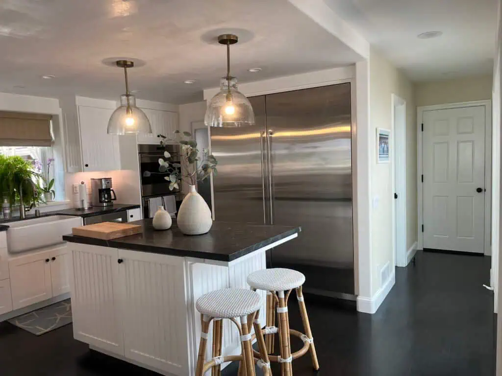 Interior kitchen with white cabinets and stainless steel appliances.