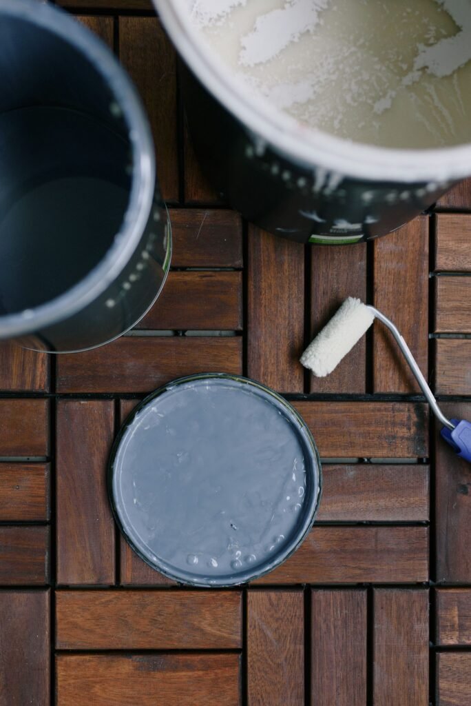 Illustrative photo: paint cans and a roller ready for a renovation