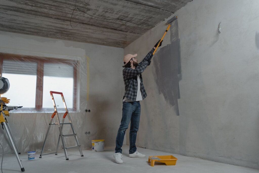Illustrative photo: professional applying paint to an interior wall